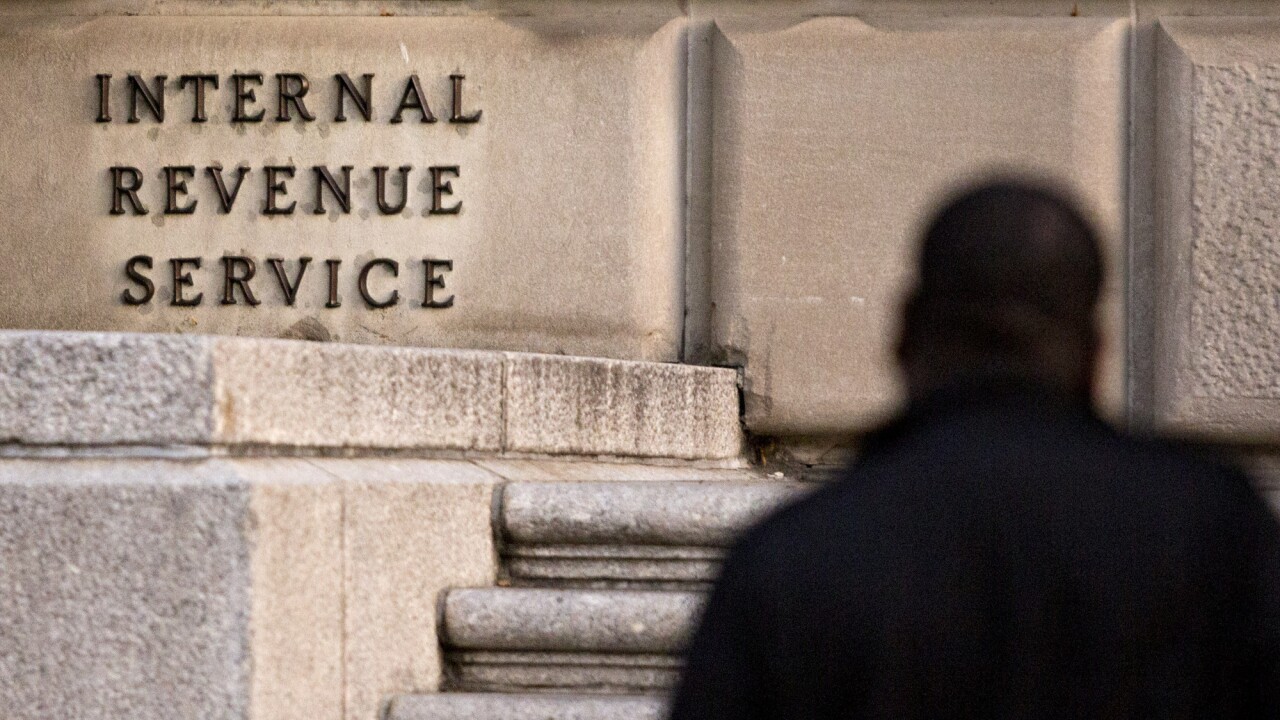 A man walks past the IRS headquarters in Washington, D.C.