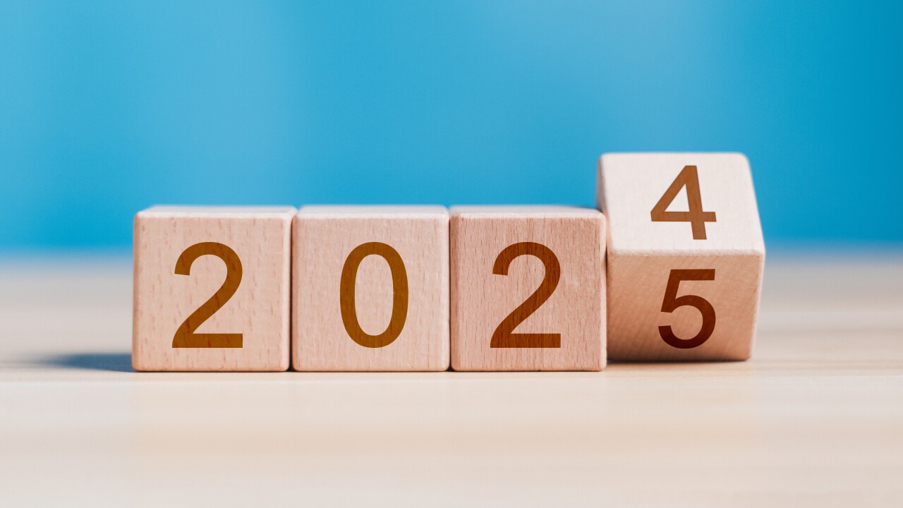 Wooden cube blocks that spell out '2024' are in the process of changing the last digit to '2025'