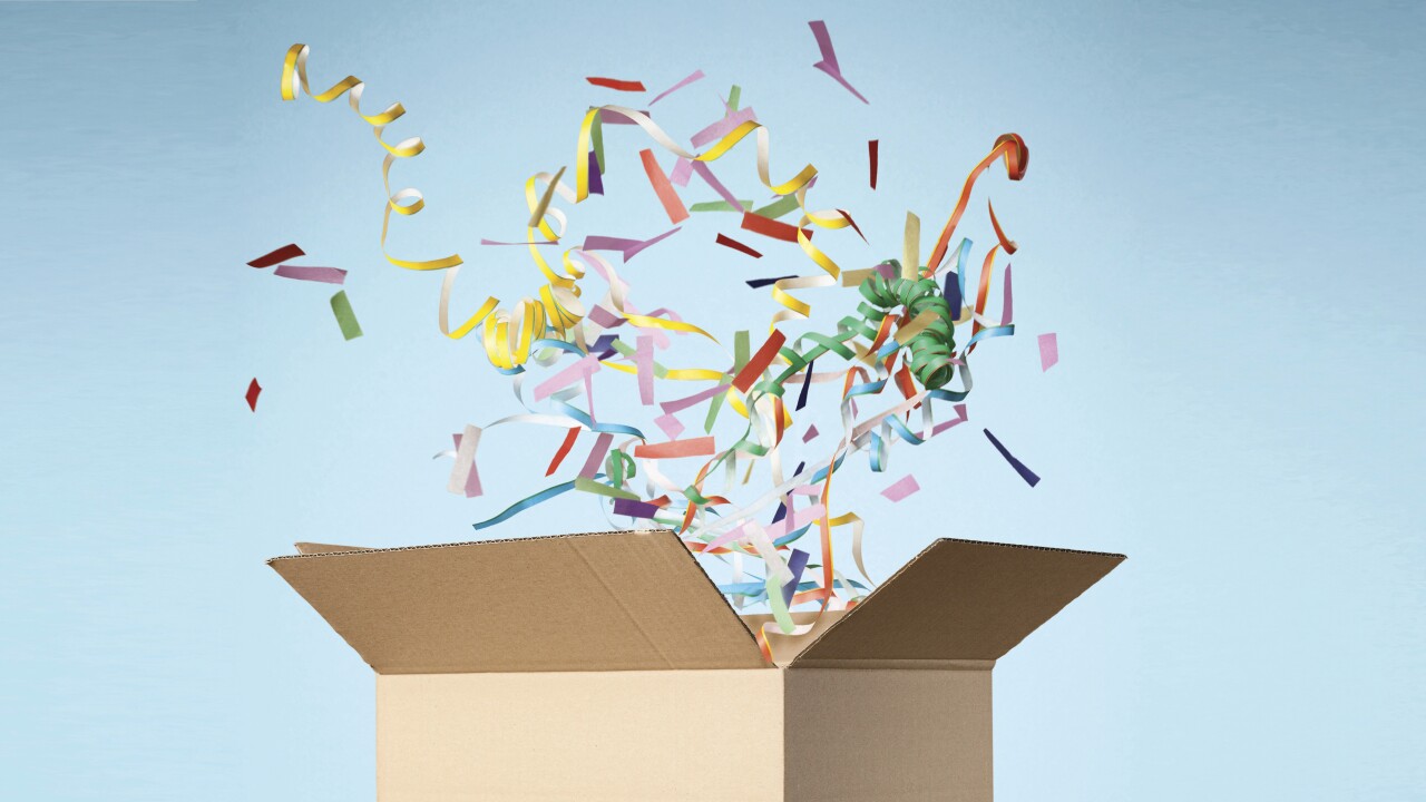 Studio shot of cardboard box with streamers exploding out