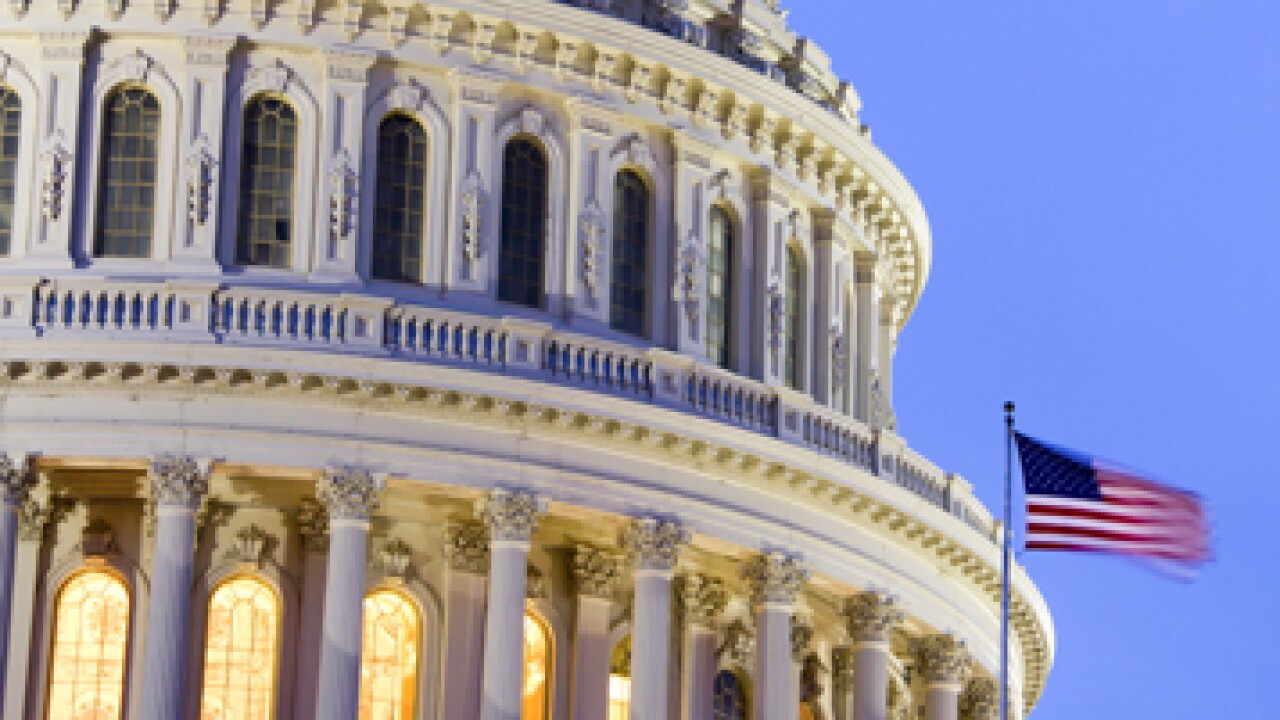 A close up of the capital building with an American flag