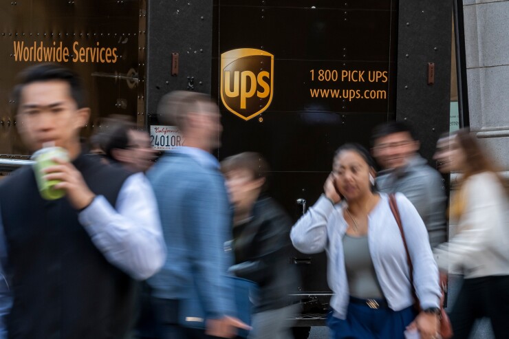 A UPS truck in San Francisco with pedestrians passing by