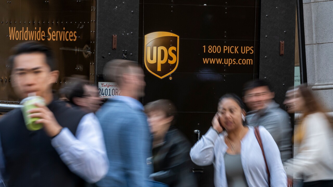 A UPS truck in San Francisco with pedestrians passing by