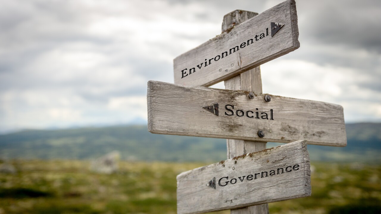 Environmental social governance (ESG) text on wooden signpost outdoors in nature