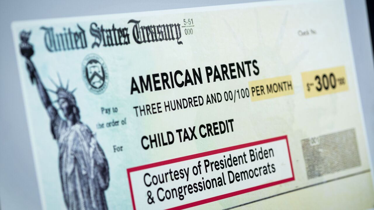 A poster of the Child Tax Credit during a news conference at the U.S. Capitol in Washington, D.C., U.S., on Thursday, July 15, 2021. The President's agenda got a boost with Senate Democratic leaders outlining plans for more than $4 trillion in domestic programs, but enactment hinges on negotiating details on Medicare, taxes, immigration and infrastructure that have confounded Congress for a generation. Photographer: Al Drago/Bloomberg